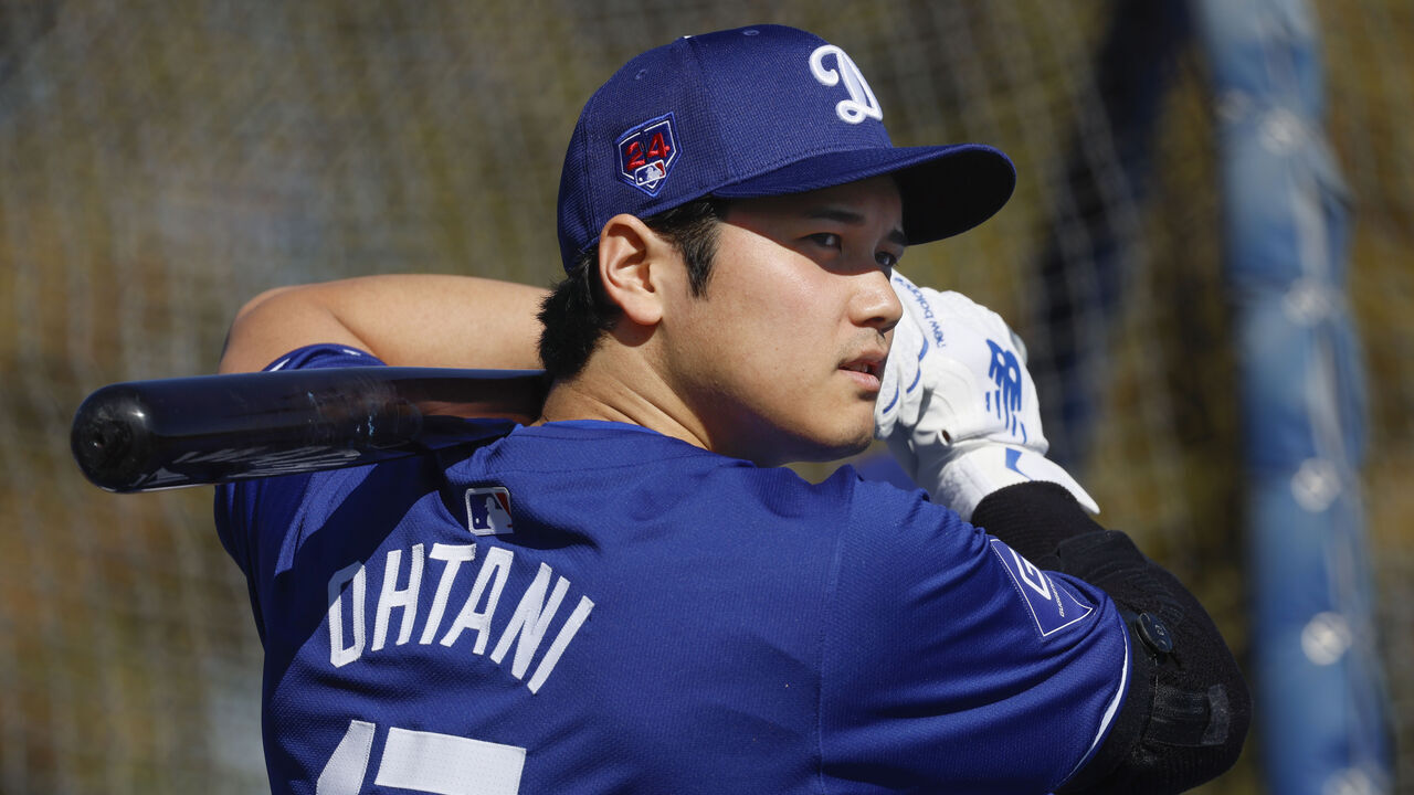 Goodyear, Arizona, Wednesday, February 14, 2024 - Shohei Ohtani warms up near the batting cage before taking some swings during Dodgers spring training. (Robert Gauthier/Los Angeles Times via Getty Images)
