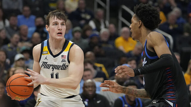 MILWAUKEE, WISCONSIN - FEBRUARY 21: Tyler Kolek #11 of the Marquette Golden Eagles dribbles the ball against Keyondre Young #11 of the DePaul Blue Demons during the first half at Fiserv Forum on February 21, 2024 in Milwaukee, Wisconsin.