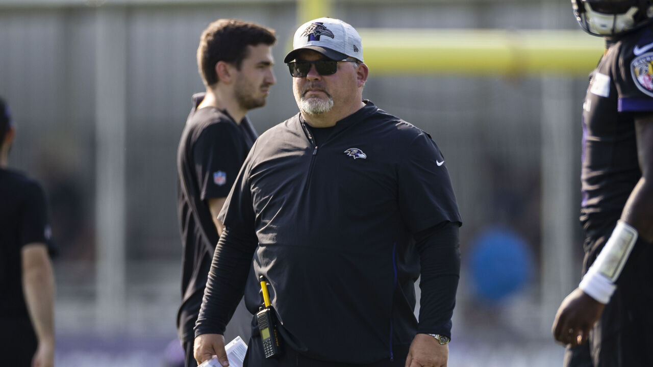 OWINGS MILLS, MD - JULY 28: Offensive coordinator Greg Roman of the Baltimore Ravens watches play during training camp at Under Armour Performance Center Baltimore Ravens on July 28, 2021 in Owings Mills, Maryland.