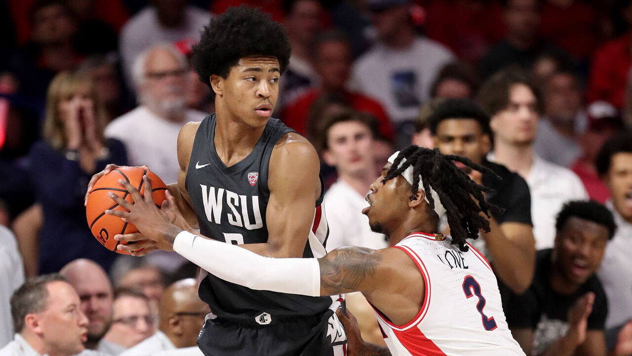 TUCSON, AZ - FEBRUARY 22: Arizona Wildcats guard Caleb Love #2 attempts to steal the ball from Washington State Cougars forward Jaylen Wells #0 uring the first half of a men's basketball game between the Washington State Cougars and the University of Arizona Wildcats on February 22, 2024 at McKale Center in Tucson, AZ.