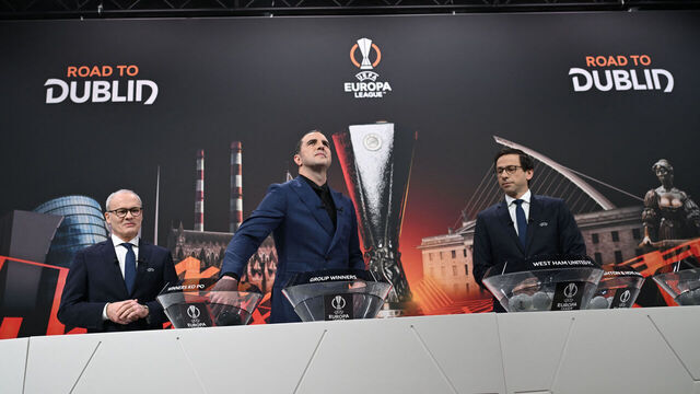 Irish former football international John O'Shea (C) picks a ball from a bowl flanked by UEFA Deputy General Secretary Giorgio Marchetti (L) and UEFA Head of Club Competitions and Calendar Tobias Hedtstuck (R) during the draw for the round of 16 of the 2023-2024 UEFA Europa League football tournament at the House of European Football in Nyon, on February 23, 2024.