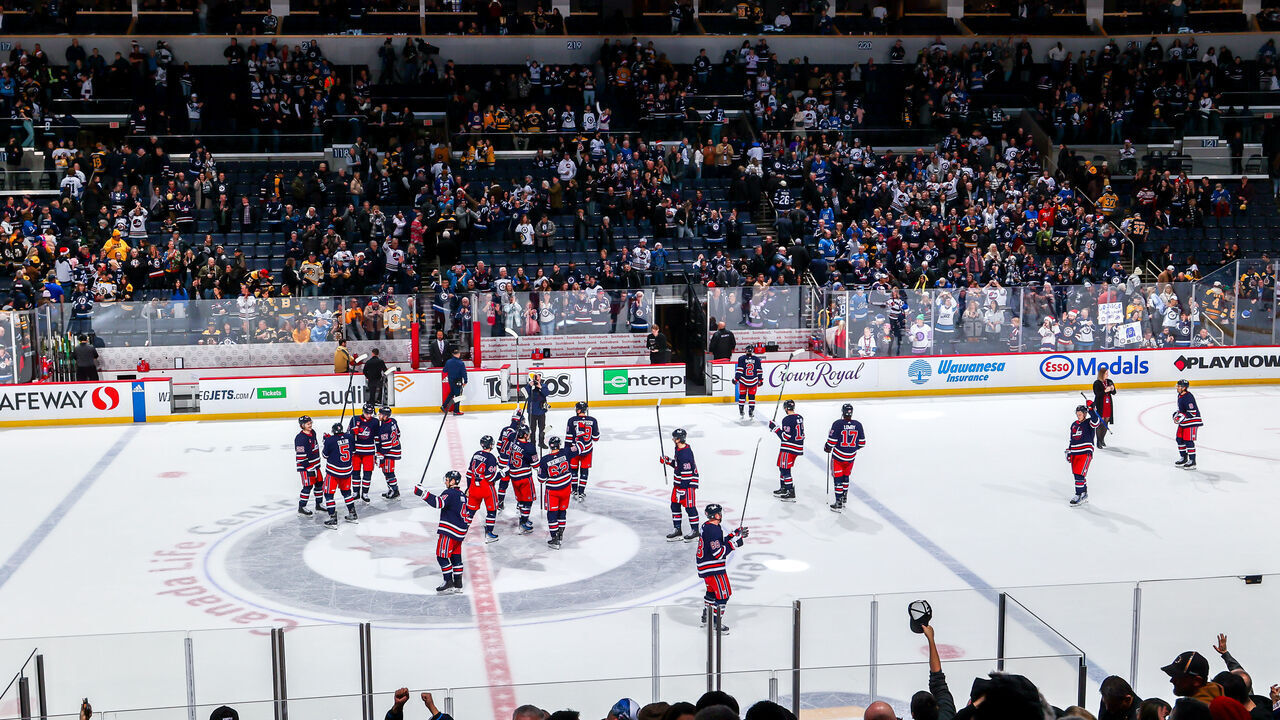 WINNIPEG, CANADA - DECEMBER 22: Winnipeg Jets players salute the fans following a 5-1 victory over the Boston Bruins at Canada Life Centre on December 22, 2023 in Winnipeg, Manitoba, Canada.