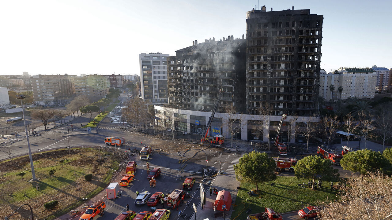 Firefighters inspect the aftermath of a huge fire that yesterday raged through a multistorey residential block killing at least four people, in Valencia on February 23, 2024. At least four people have died in a vast fire that ripped through a 14-storey apartment block in Valencia in eastern Spain, but officials warned today that the death toll could rise sharply. Fourteen people are still missing, the regional administrator said.