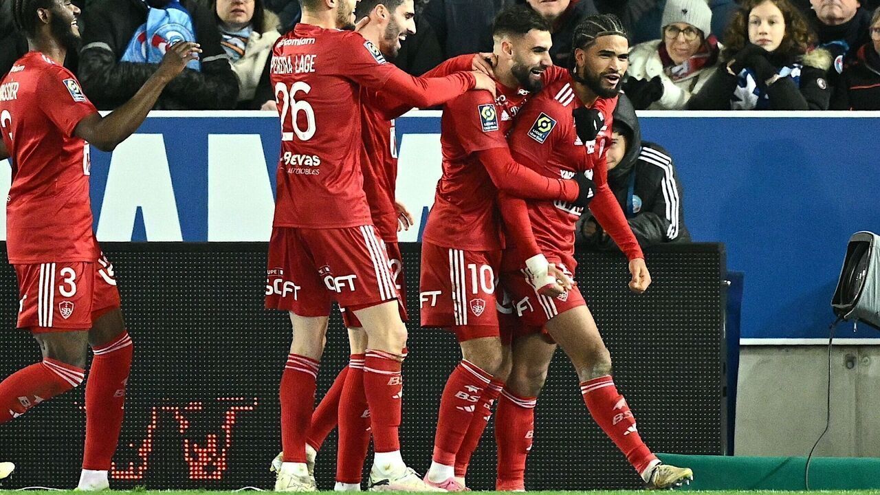 Brest's French Gambian midfielder #45 Mahdi Camara (R) celebrates scoring his team's third goal during the French L1 football match between RC Strasbourg Alsace and stade Brestois 29 at the Stade de la Meinau in Strasbourg, eastern France, on February 24, 2024.