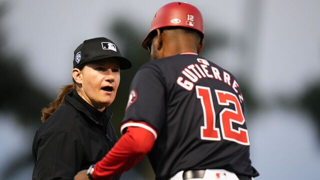 WEST PALM BEACH, FLORIDA - FEBRUARY 24: Umpire Jen Pawol shakes the hand of Washington Nationals third base coach Ricky Guiterrez #12 duringa spring training game against the Houston Astros at CACTI Park of the Palm Beaches on February 24, 2024 in West Palm Beach, Florida.