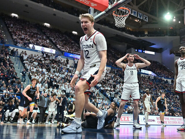 HARTFORD, CT - FEBRUARY 17: UConn Huskies guard Cam Spencer (12) and UConn Huskies forward Alex Karaban (11) react to the play during the game as the Marquette Golden Eagles take on the UConn Huskies on February 17, 2024 at the XL Center in Hartford, CT
