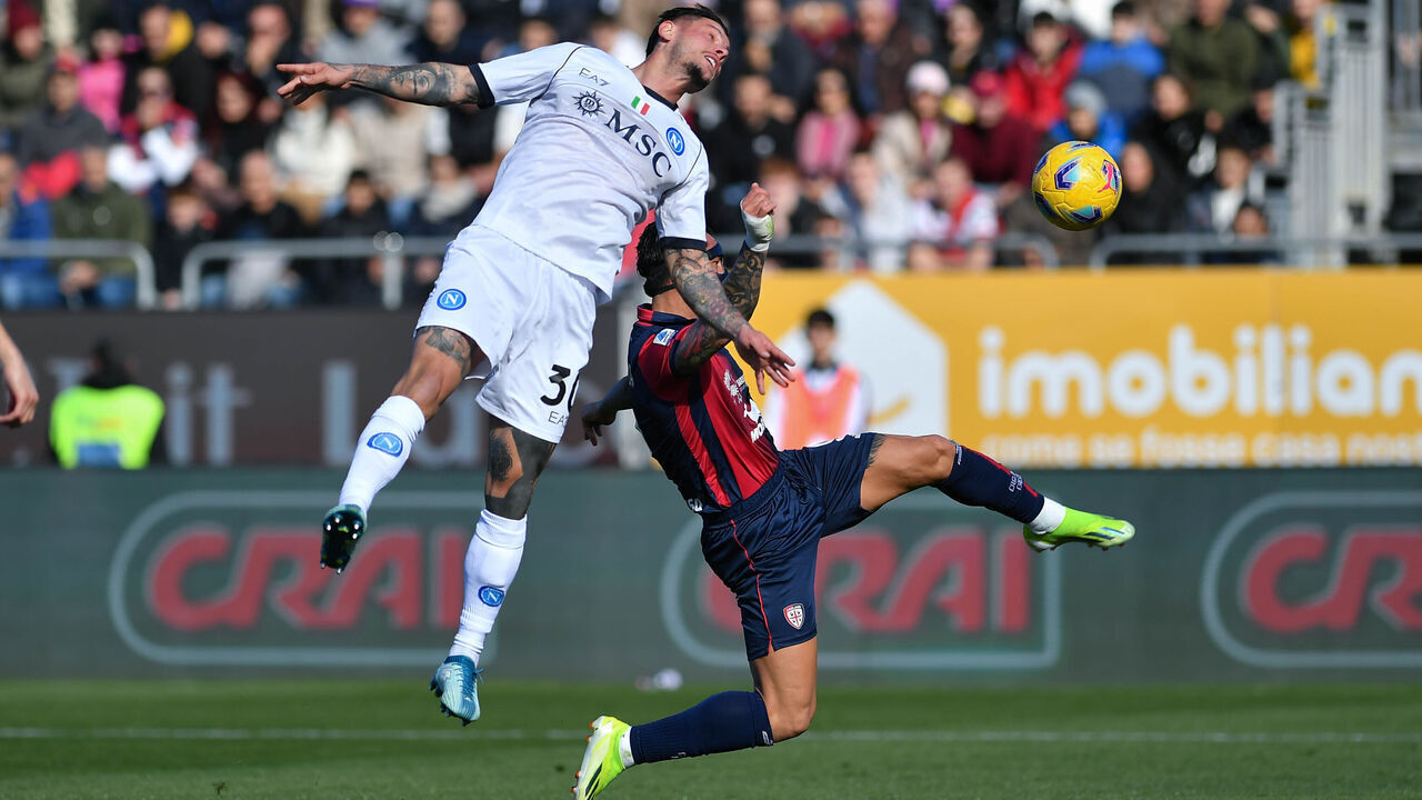 CAGLIARI, ITALY - FEBRUARY 25: Pasquale Mazzocchi of SSC Napoli competes for the ball with Cagliari Calcio Gianluca Lapadula during the Serie A TIM match between Cagliari and SSC Napoli at Sardegna Arena on February 25, 2024 in Cagliari, Italy.