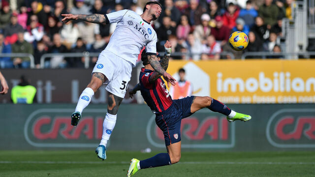 CAGLIARI, ITALY - FEBRUARY 25: Pasquale Mazzocchi of SSC Napoli competes for the ball with Cagliari Calcio Gianluca Lapadula during the Serie A TIM match between Cagliari and SSC Napoli at Sardegna Arena on February 25, 2024 in Cagliari, Italy.