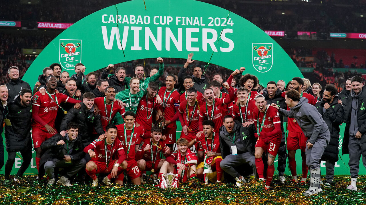 Liverpool players celebrate on the pitch with the trophy after winning the Carabao Cup final at Wembley Stadium, London. Picture date: Sunday February 25, 2024.