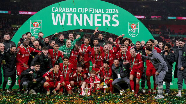 Liverpool players celebrate on the pitch with the trophy after winning the Carabao Cup final at Wembley Stadium, London. Picture date: Sunday February 25, 2024.