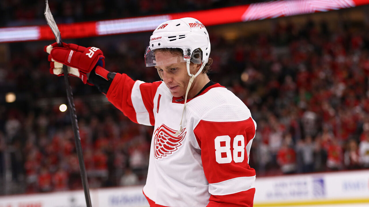 CHICAGO, IL - FEBRUARY 25: Patrick Kane #88 of the Detroit Red Wings raises his stick after overtime against the Chicago Blackhawks at the United Center on February 25, 2024 in Chicago, Illinois.