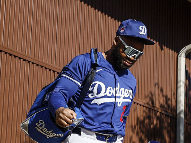 Goodyear, Arizona, Wednesday, February 14, 2024 - Teoscoar Hernandez, center, arrives with teammates Manuel Margot, left, and Miguel Vargas, right, as Dodgers full squad spring training workouts begin. (Robert Gauthier/Los Angeles Times via Getty Images)