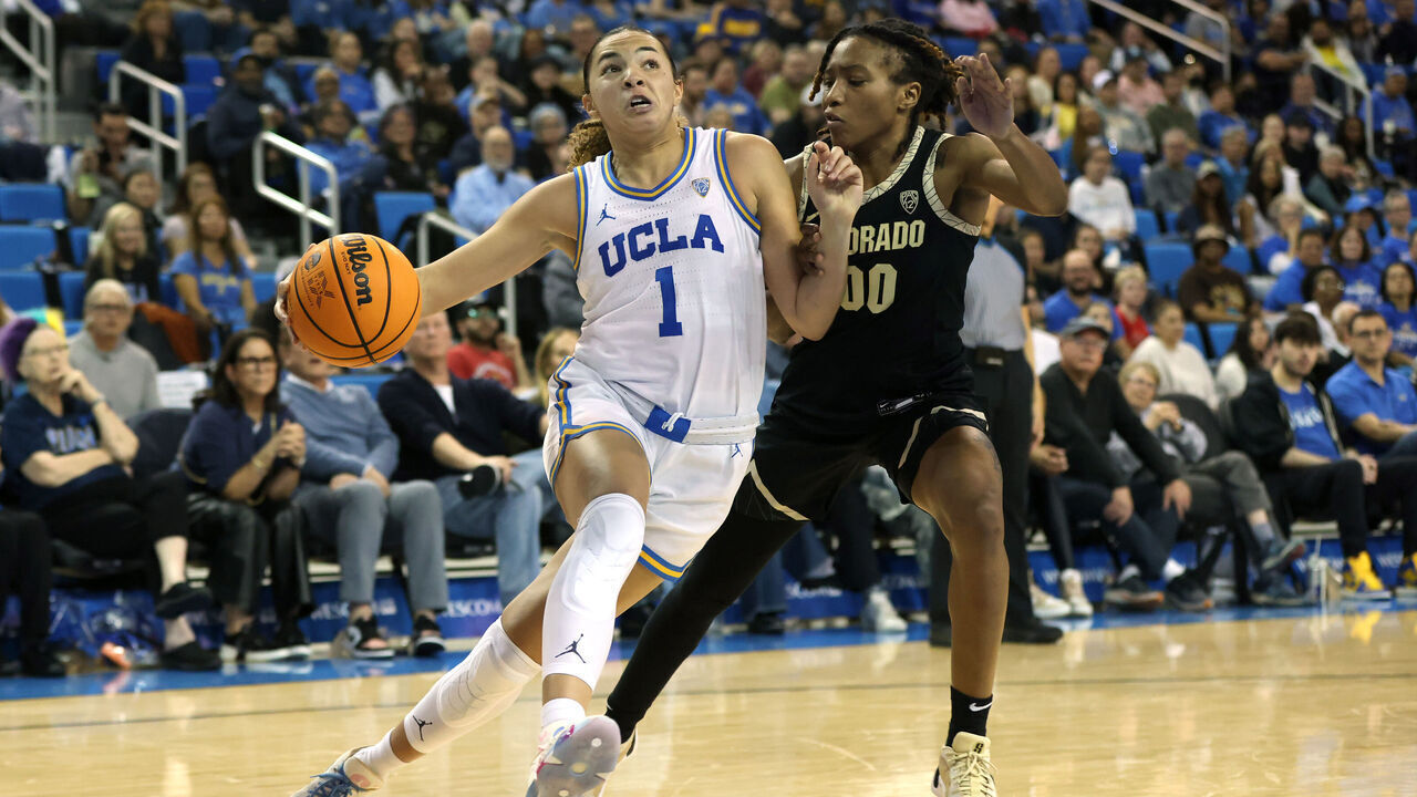 LOS ANGELES, CALIFORNIA - FEBRUARY 26: Kiki Rice #1 of the UCLA Bruins drives around Jaylyn Sherrod #00 of the Colorado Buffaloes during the second half of a game at UCLA Pauley Pavilion on February 26, 2024 in Los Angeles, California.
