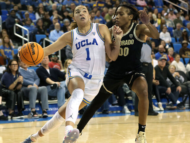 LOS ANGELES, CALIFORNIA - FEBRUARY 26: Kiki Rice #1 of the UCLA Bruins drives around Jaylyn Sherrod #00 of the Colorado Buffaloes during the second half of a game at UCLA Pauley Pavilion on February 26, 2024 in Los Angeles, California.