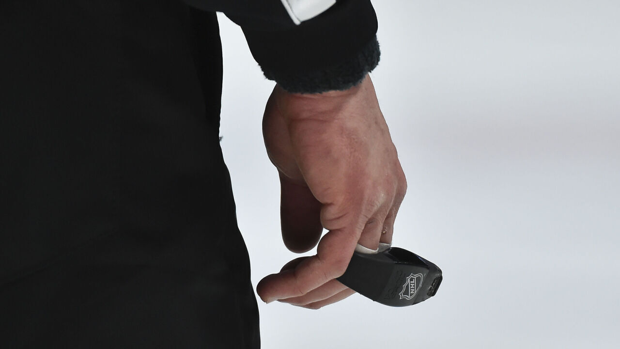 MONTREAL, QC - JANUARY 30: A branded NHL whistle is held by a referee during the third period between the Montreal Canadiens and the Calgary Flames at the Bell Centre on January 30, 2021 in Montreal, Canada. The Calgary Flames defeated the Montreal Canadiens 2-0.