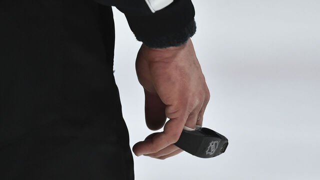 MONTREAL, QC - JANUARY 30: A branded NHL whistle is held by a referee during the third period between the Montreal Canadiens and the Calgary Flames at the Bell Centre on January 30, 2021 in Montreal, Canada. The Calgary Flames defeated the Montreal Canadiens 2-0.