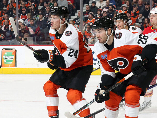 PHILADELPHIA, PENNSYLVANIA - JANUARY 06: Nick Seeler #24, Sean Walker #26 and Bobby Brink #10 of the Philadelphia Flyers defend Connor Zary #47 of the Calgary Flames at the Wells Fargo Center on January 6, 2024 in Philadelphia, Pennsylvania.