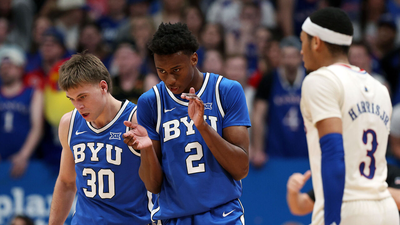 LAWRENCE, KANSAS - FEBRUARY 27: Jaxson Robinson #2 and Dallin Hall #30 of the Brigham Young Cougars react after a foul during the 2nd half of the game against the Kansas Jayhawks at Allen Fieldhouse on February 27, 2024 in Lawrence, Kansas.