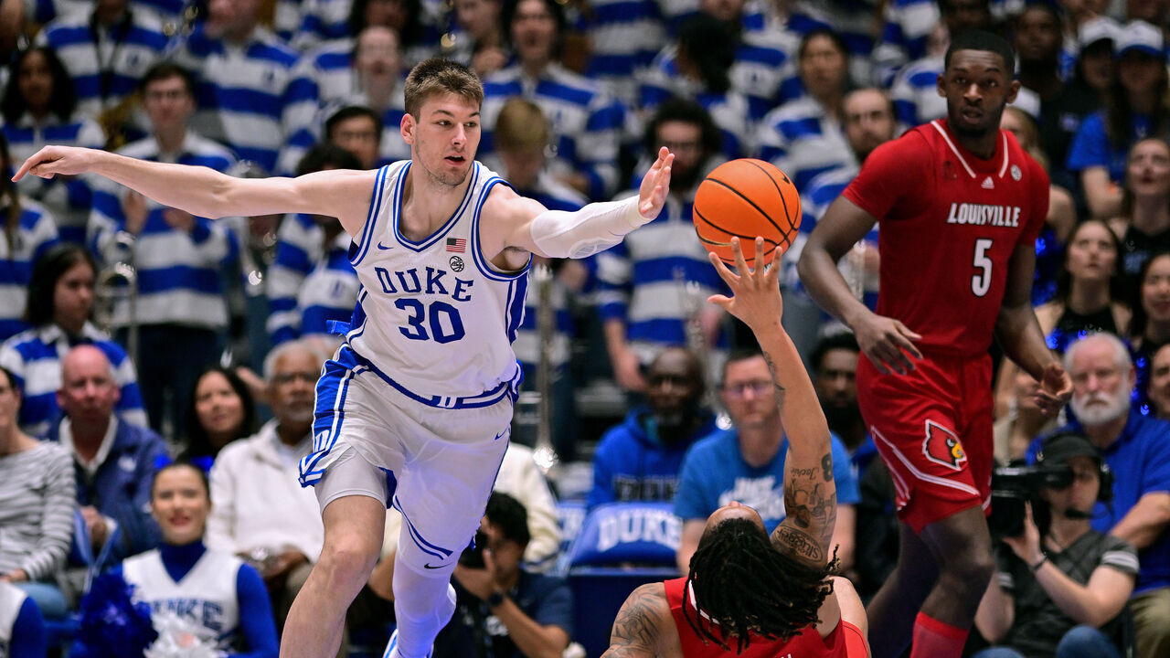 DURHAM, NORTH CAROLINA - FEBRUARY 28: Kyle Filipowski #30 of the Duke Blue Devils battles Kaleb Glenn #10 of the Louisville Cardinals for a loose ball during the second half of the game at Cameron Indoor Stadium on February 28, 2024 in Durham, North Carolina.