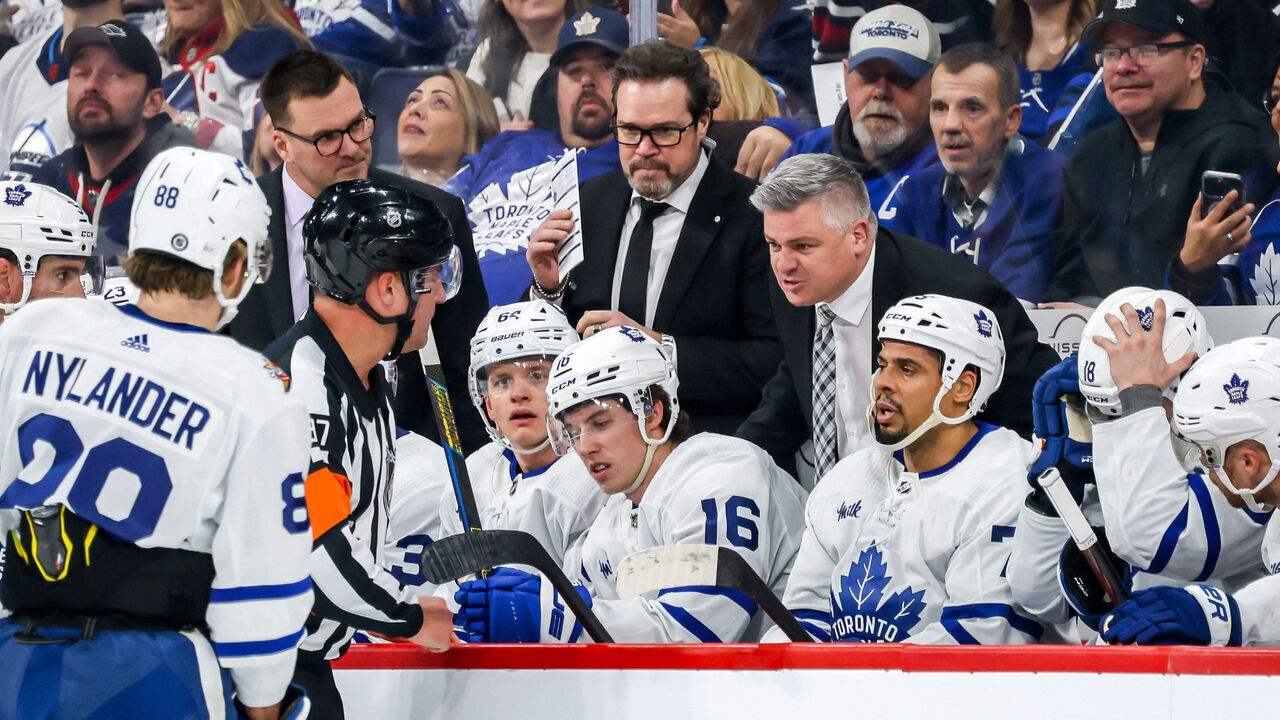 WINNIPEG, CANADA - JANUARY 27: Head Coach Sheldon Keefe of the Toronto Maple Leafs has words with referee Pierre Lambert #37 during a first period stoppage in play against the Winnipeg Jets at the Canada Life Centre on January 27, 2024 in Winnipeg, Manitoba, Canada.
