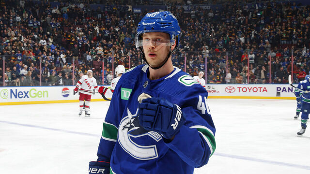 VANCOUVER, CANADA - DECEMBER 09: Elias Pettersson #40 of the Vancouver Canucks is congratulated by teammates after scoring during their NHL game against the Carolina Hurricanes at Rogers Arena on December 9, 2023 in Vancouver, British Columbia, Canada.