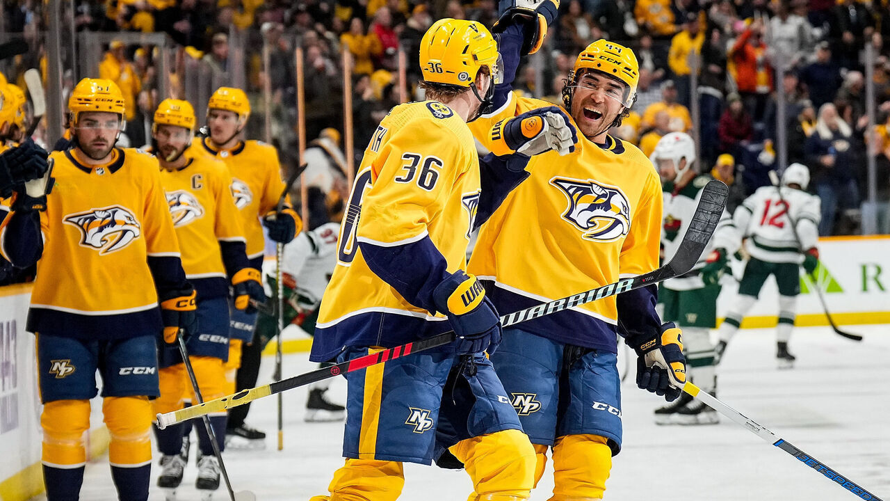 NASHVILLE, TENNESSEE - FEBRUARY 29: Cole Smith #36 high-fives Kiefer Sherwood #44 of the Nashville Predators after his goal against the Minnesota Wild during an NHL game at Bridgestone Arena on February 29, 2024 in Nashville, Tennessee.