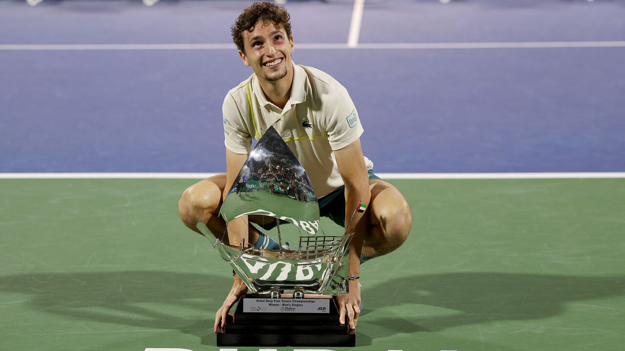 DUBAI, UNITED ARAB EMIRATES - MARCH 02: Ugo Humbert of France celebrates victory with the trophy over Alexander Bublik of Kazakhstan in the final match during the Dubai Duty Free Tennis Championships at Dubai Duty Free Tennis Stadium on March 02, 2024 in Dubai, United Arab Emirates.