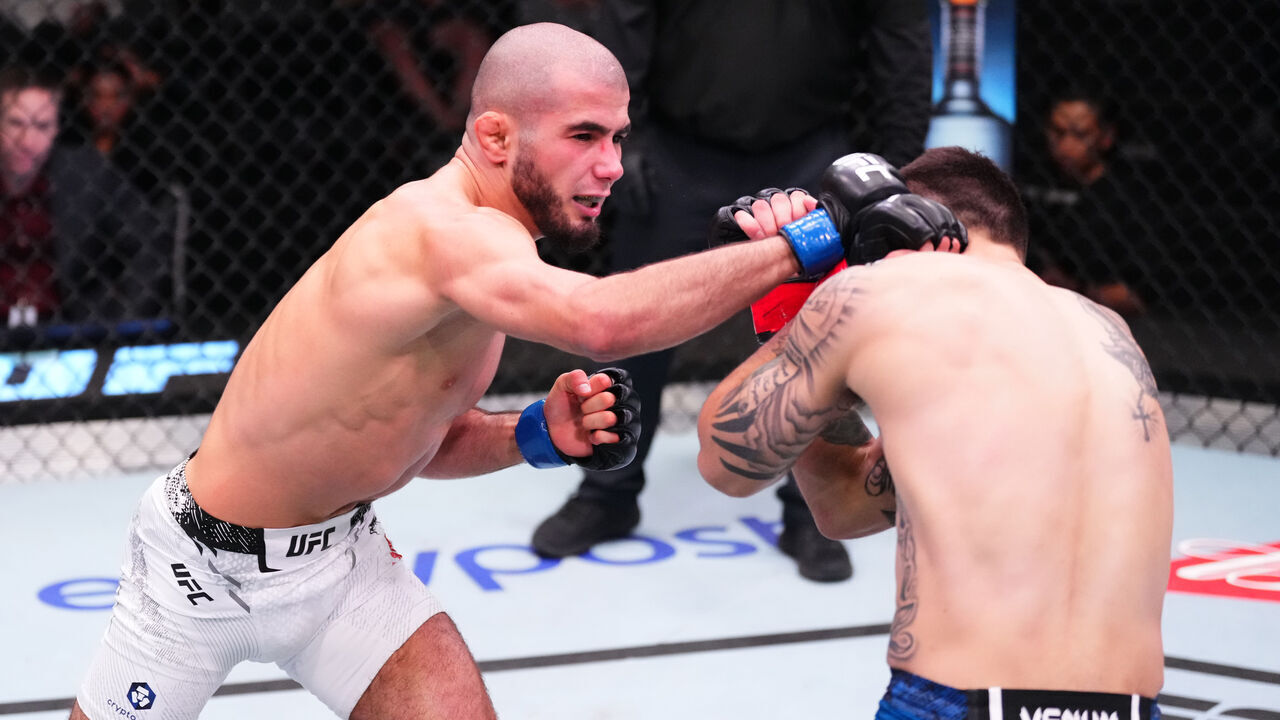 LAS VEGAS, NEVADA - MARCH 02: (L-R) Muhammad Mokaev of Russia punches Alex Perez in a flyweight bout during the UFC Fight Night event at UFC APEX on March 02, 2024 in Las Vegas, Nevada.