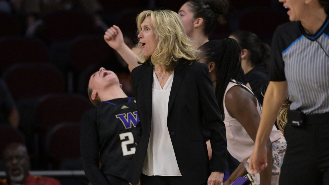 LOS ANGELES, CALIFORNIA - JANUARY 28: Head coach Tina Langley and the Washington Huskies bench celebrate after a basket in the second half against the USC Trojans at Galen Center on January 28, 2024 in Los Angeles, California.