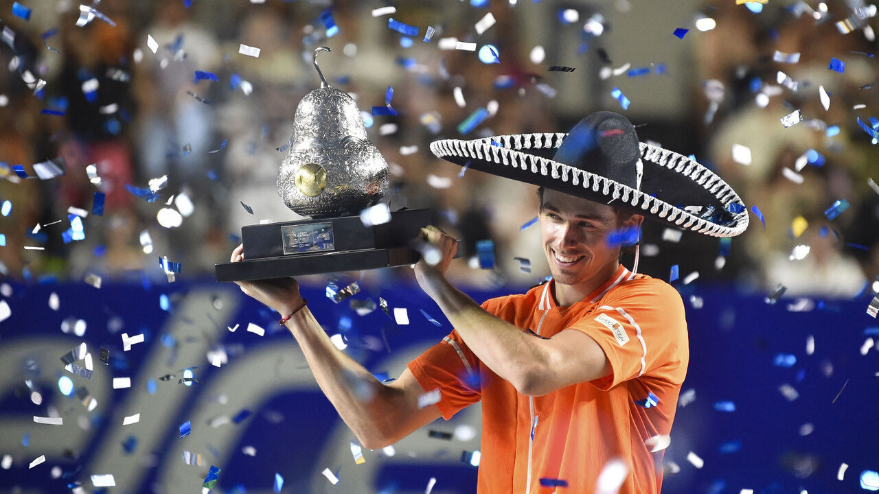 Australia's Alex De Minaur celebrates with his trophy after winning the Mexico ATP Open 500 men's singles final tennis match against Norway's Casper Ruud at the Arena GNP Seguros in Acapulco, Guerrero State, Mexico on March 2, 2024.