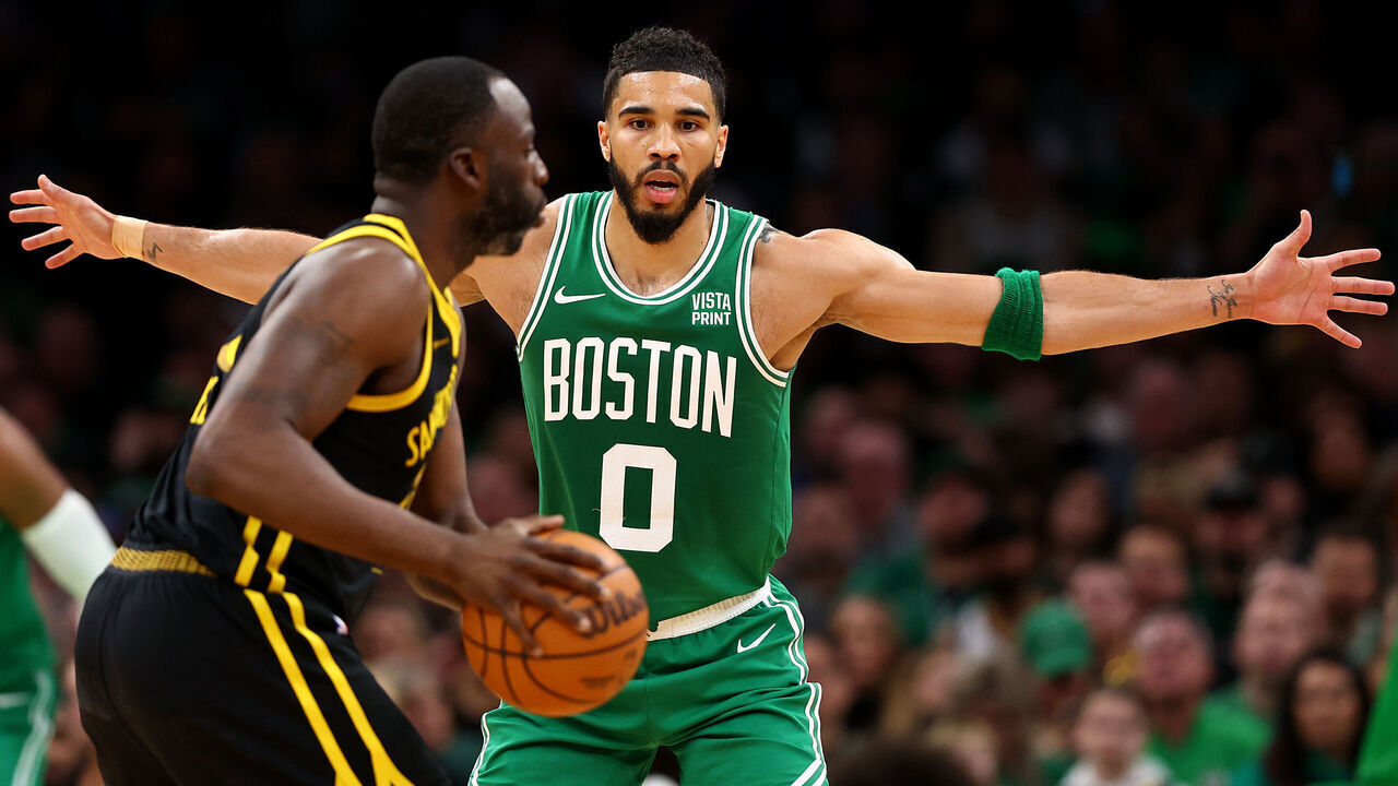 BOSTON, MASSACHUSETTS - MARCH 03: Jayson Tatum #0 of the Boston Celtics defends Draymond Green #23 of the Golden State Warriors during the second quarter at TD Garden on March 03, 2024 in Boston, Massachusetts.