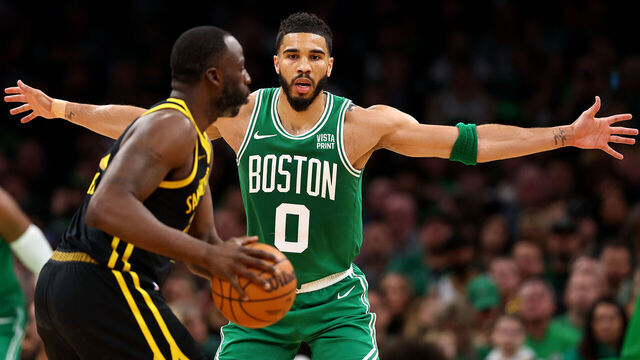 BOSTON, MASSACHUSETTS - MARCH 03: Jayson Tatum #0 of the Boston Celtics defends Draymond Green #23 of the Golden State Warriors during the second quarter at TD Garden on March 03, 2024 in Boston, Massachusetts.