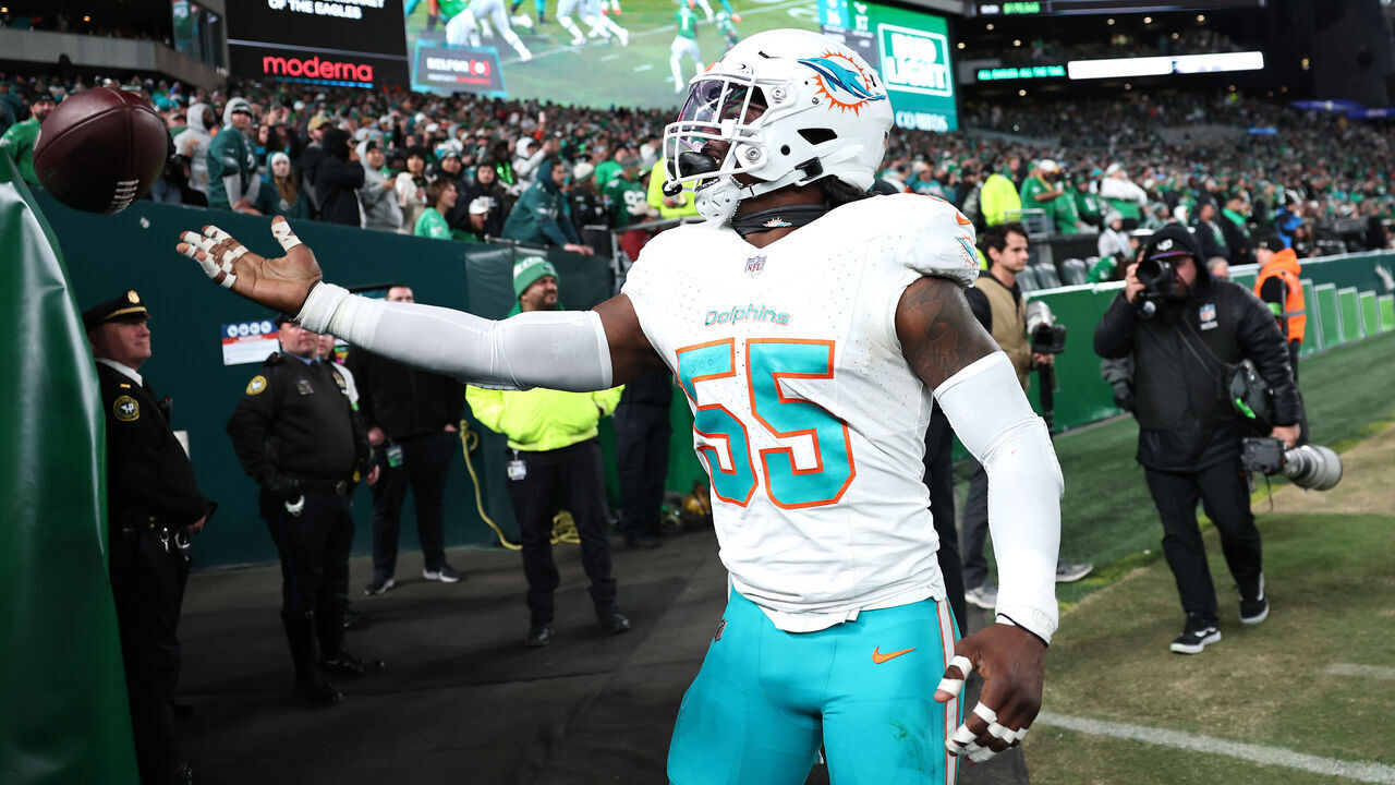 PHILADELPHIA, PENNSYLVANIA - OCTOBER 22: Jerome Baker #55 of the Miami Dolphins tosses the ball to fans after scoring a touchdown on an interception against the Philadelphia Eagles during the second half of a game at Lincoln Financial Field on October 22, 2023 in Philadelphia, Pennsylvania.
