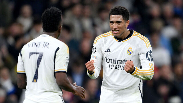 MADRID, SPAIN - MARCH 06: Vinicius Junior of Real Madrid celebrates Jude Bellingham of Real Madrid after scoring his team's first goal during the UEFA Champions League 2023/24 round of 16 second leg match between Real Madrid CF and RB Leipzig at Estadio Santiago Bernabeu on March 06, 2024 in Madrid, Spain.
