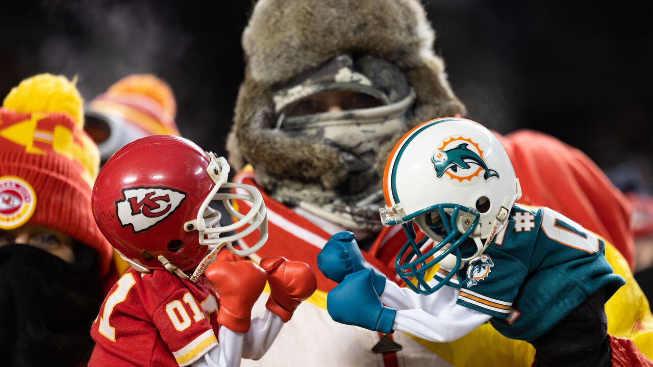 KANSAS CITY, MISSOURI - JANUARY 13: A fan holds fighting puppets during an NFL wild-card playoff football game between the Miami Dolphins and Kansas City Chiefs at GEHA Field at Arrowhead Stadium on January 13, 2024 in Kansas City, Missouri.