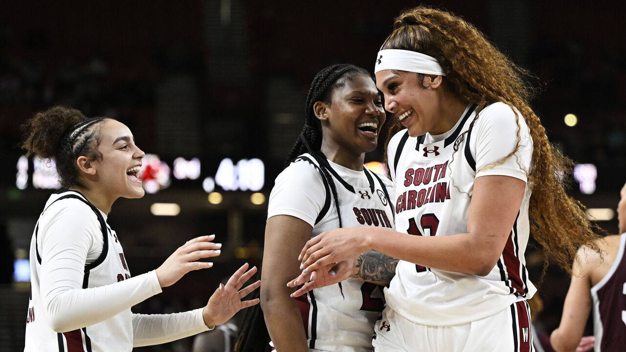 GREENVILLE, SOUTH CAROLINA - MARCH 08: Kamilla Cardoso #10, Sania Feagin #20, and Tessa Johnson #5 of the South Carolina Gamecocks celebrate against the Texas A&M Aggies in the third quarter during the quarterfinals of the SEC Women's Basketball Tournament at Bon Secours Wellness Arena on March 08, 2024 in Greenville, South Carolina.