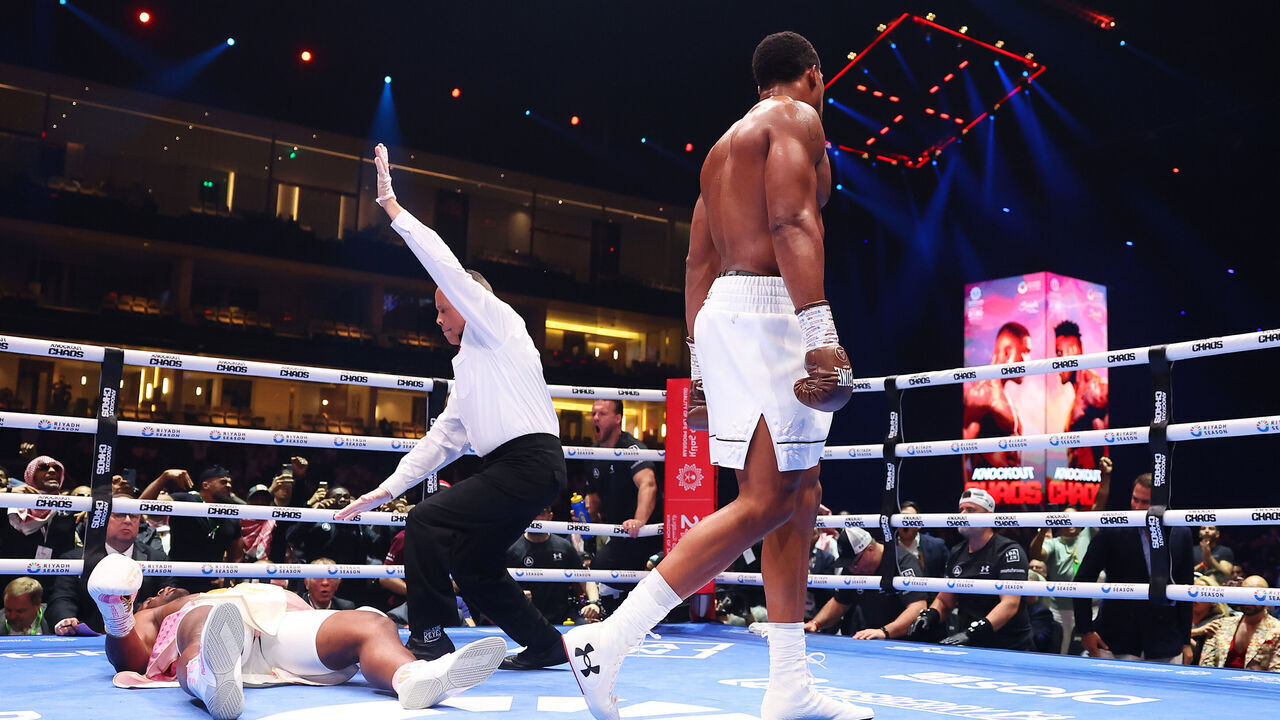 RIYADH, SAUDI ARABIA - MARCH 08: Francis Ngannou is knocked down for the third time as Referee Ricky Gonzalez checks on him during the Heavyweight fight between Anthony Joshua and Francis Ngannou on the Knockout Chaos boxing card at the Kingdom Arena on March 08, 2024 in Riyadh, Saudi Arabia.