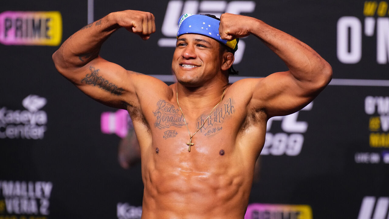 MIAMI, FLORIDA - MARCH 08: Gilbert Burns of Brazil poses on the scale during the UFC 299 ceremonial weigh-in at Kaseya Center on March 08, 2024 in Miami, Florida.