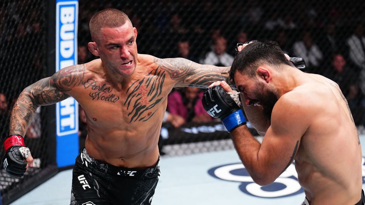 MIAMI, FLORIDA - MARCH 09: (L-R) Dustin Poirier punches Benoit Saint Denis of France in a lightweight fight during the UFC 299 event at Kaseya Center on March 09, 2024 in Miami, Florida.