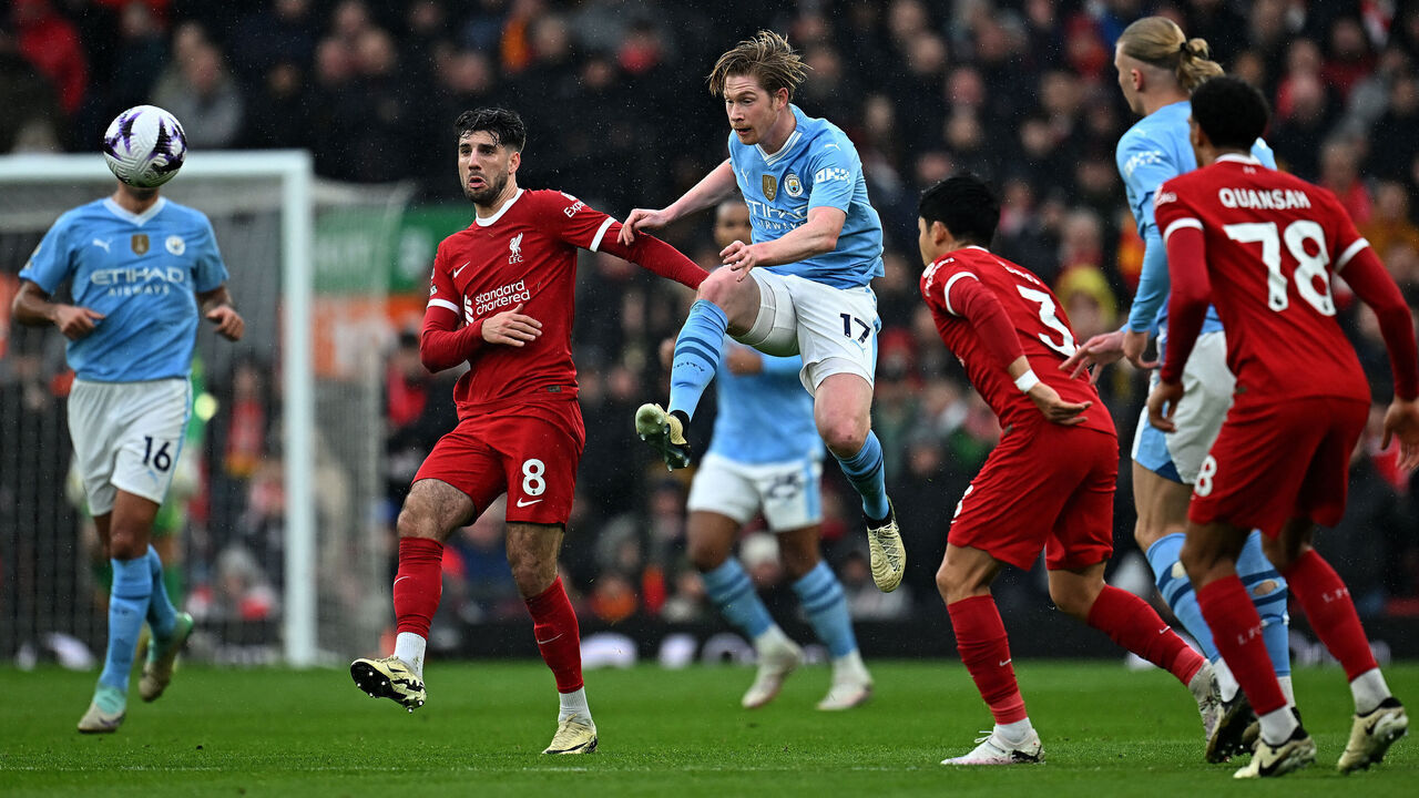 Manchester City's Belgian midfielder #17 Kevin De Bruyne jumps to control the ball during the English Premier League football match between Liverpool and Manchester City at Anfield in Liverpool, north west England on March 10, 2024.