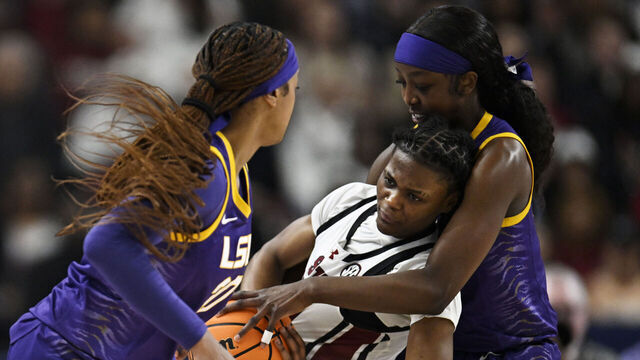 GREENVILLE, SOUTH CAROLINA - MARCH 10: Flau'jae Johnson #4, Janae Kent #20 of the LSU Lady Tigers, and MiLaysia Fulwiley #12 of the South Carolina Gamecocks wrestle for a ball in the first quarter during the championship game of the SEC Women's Basketball Tournament at Bon Secours Wellness Arena on March 10, 2024 in Greenville, South Carolina.
