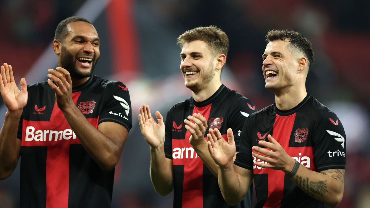 LEVERKUSEN, GERMANY - MARCH 10: Jonathan Tah, Josip Stanisic and Granit Xhaka of Bayer Leverkusen celebrate victory following the Bundesliga match between Bayer 04 Leverkusen and VfL Wolfsburg at the BayArena on March 10, 2024 in Leverkusen, Germany.