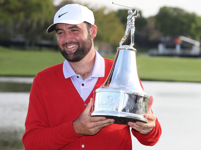 ORLANDO, FL - MARCH 10: PGA golfer Scottie Scheffler poses with the trophy and in the red cardigan sweater after winning the Arnold Palmer Invitational presented by MasterCard at the Arnold Palmer's Bay Hill Club & Lodge on March 10, 2024, in Orlando, Florida.
