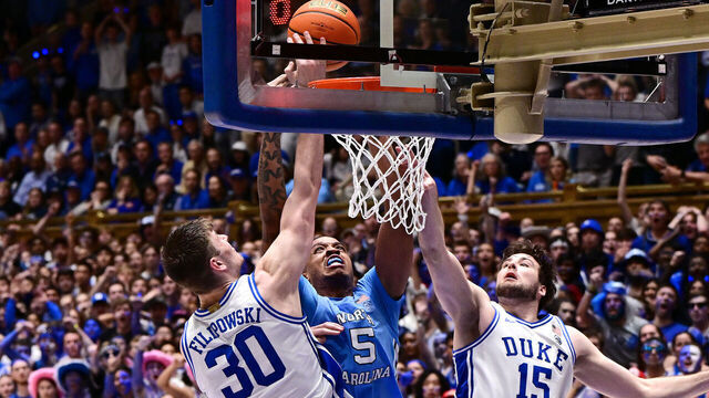 DURHAM, NORTH CAROLINA - MARCH 09: Kyle Filipowski #30 of the Duke Blue Devils blocks a shot by Armando Bacot #5 of the North Carolina Tar Heels during the second half of the game at Cameron Indoor Stadium on March 09, 2024 in Durham, North Carolina.The Tar Heels won 84-79.