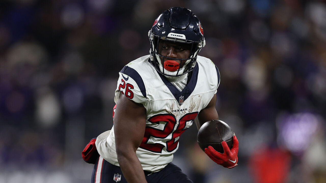 BALTIMORE, MARYLAND - JANUARY 20: Running back Devin Singletary #26 of the Houston Texans rushes against the Baltimore Ravens in the AFC Divisional Playoff game at M&T Bank Stadium on January 20, 2024 in Baltimore, Maryland.