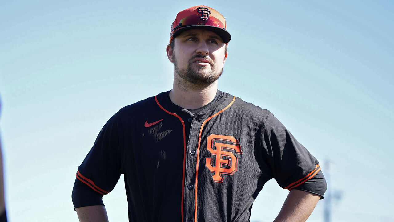SCOTTSDALE, ARIZONA - FEBRUARY 19: J.D. Davis (R) of the San Francisco Giants talks during the San Francisco Giants Spring Training workout at Scottsdale Stadium on February 19, 2024 in Scottsdale, Arizona.