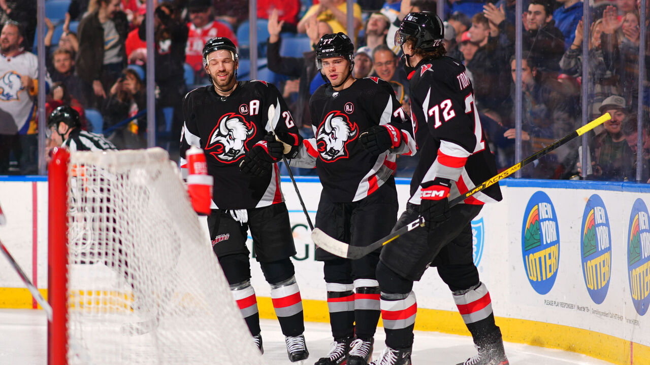 BUFFALO, NEW YORK - MARCH 12: JJ Peterka #77 celebrates his second period goal with Zemgus Girgensons #28 and Tage Thompson #72 of the Buffalo Sabres during an NHL game against the Detroit Red Wings on March 12, 2024 at KeyBank Center in Buffalo, New York.