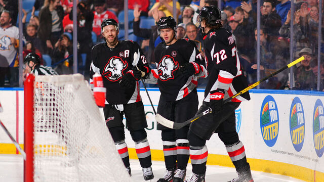 BUFFALO, NEW YORK - MARCH 12: JJ Peterka #77 celebrates his second period goal with Zemgus Girgensons #28 and Tage Thompson #72 of the Buffalo Sabres during an NHL game against the Detroit Red Wings on March 12, 2024 at KeyBank Center in Buffalo, New York.