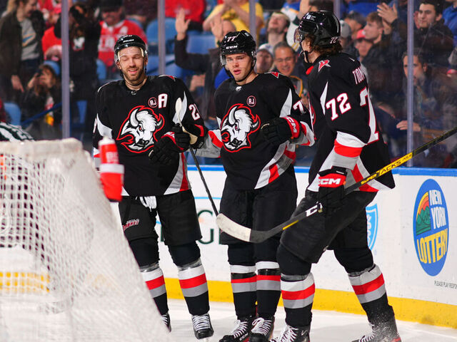 BUFFALO, NEW YORK - MARCH 12: JJ Peterka #77 celebrates his second period goal with Zemgus Girgensons #28 and Tage Thompson #72 of the Buffalo Sabres during an NHL game against the Detroit Red Wings on March 12, 2024 at KeyBank Center in Buffalo, New York.