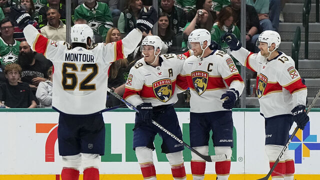 DALLAS, TEXAS - MARCH 12: Aleksander Barkov #16 of the Florida Panthers is congratulated by Matthew Tkachuk #19 and Sam Reinhart #13 after scoring a goal during the third period against the Dallas Starsat American Airlines Center on March 12, 2024 in Dallas, Texas.